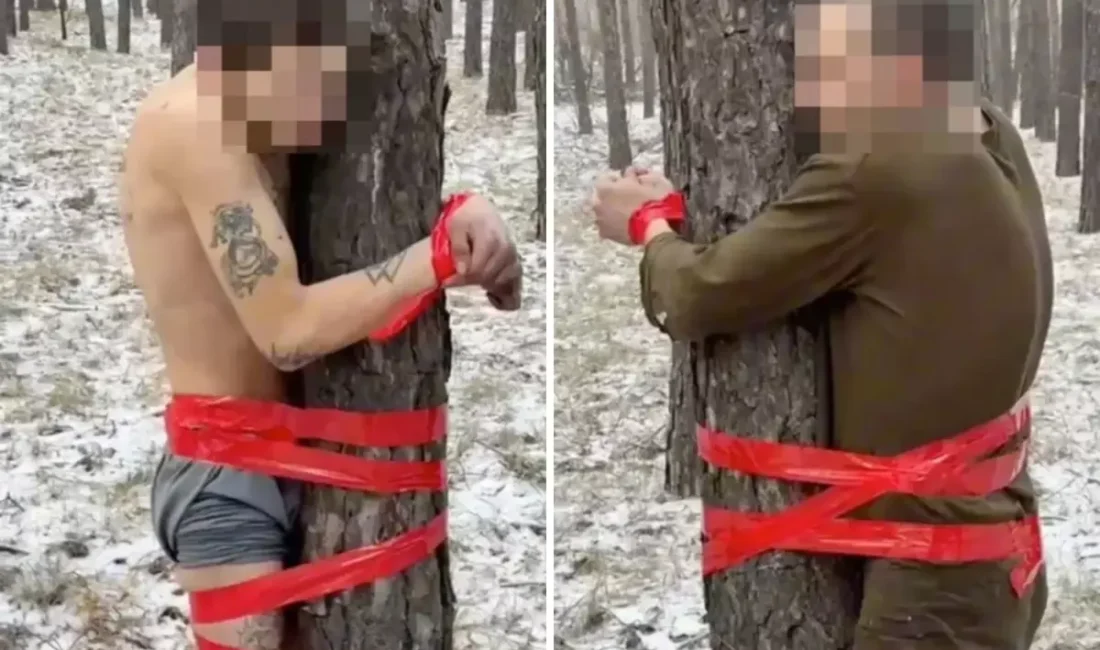 Donmuş ormanın ortasında, neredeyse çıplak halde ağaca bantlanmış iki Rus